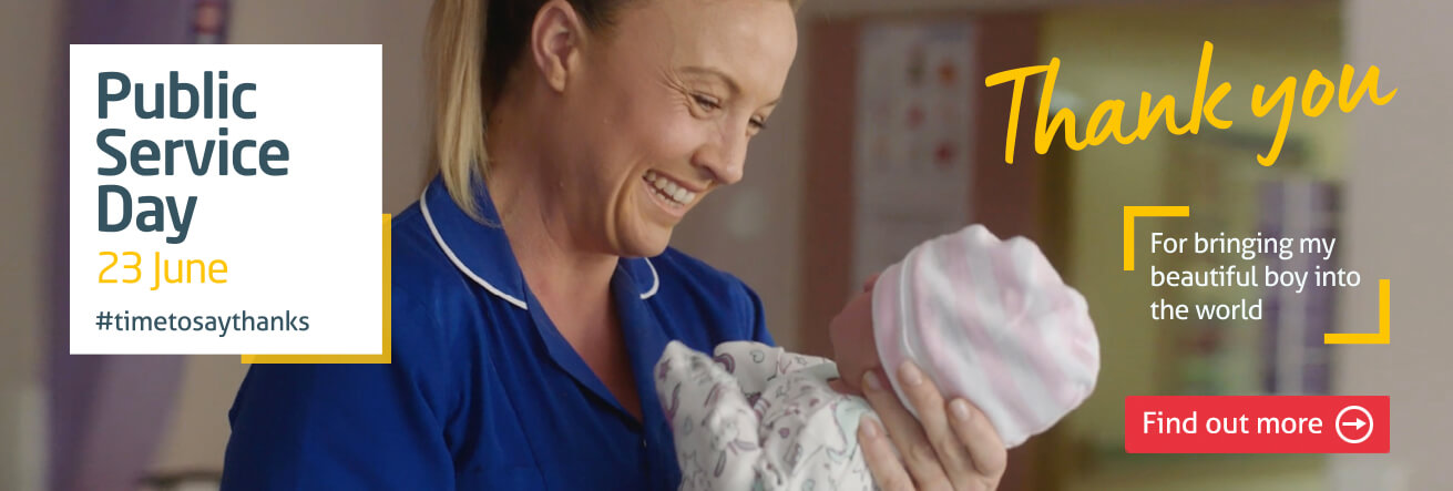 Midwife smiling at newborn baby